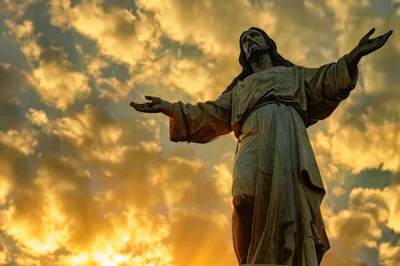 Statue Of Jesus Christ With Open Arms At Sunset