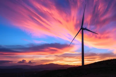 Wind Turbine Silhouette Against Vibrant Sunset Sky