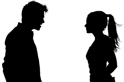Silhouettes Of A Man And Woman Facing Each Other
