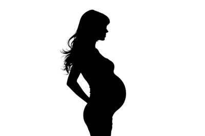 Silhouette Of A Pregnant Woman Standing In Profile