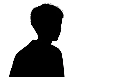 Silhouette Of A Young Boy Looking Away