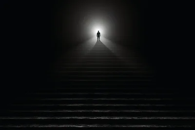 Silhouette Of A Person Walking Up Dark Stairs