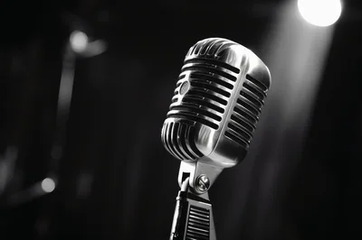 Vintage Silver Microphone Under Dramatic Stage Spotlight