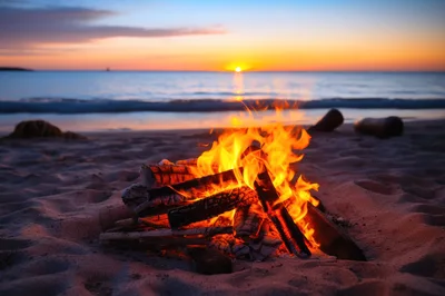 Bonfire Burning On A Sandy Beach At Sunset