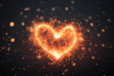 Glowing Sparkler Heart Shape Against Dark Background