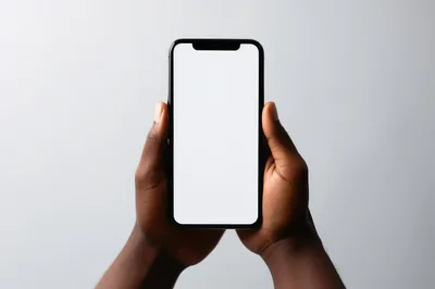 Person Holding Smartphone With Blank White Screen