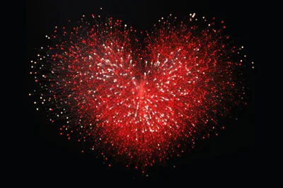 Heart Shaped Fireworks Display Against Black Sky
