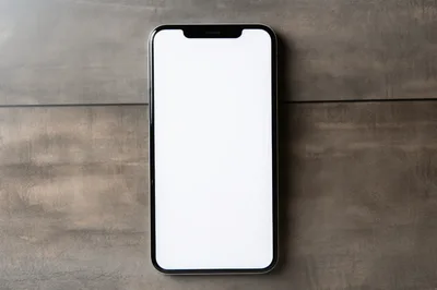 Smartphone With Blank White Screen On Wooden Surface