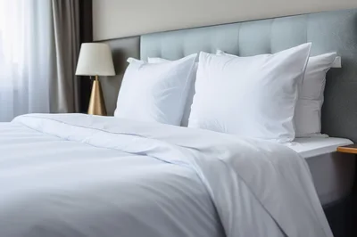 White Bedding With Pillows In A Modern Hotel Room