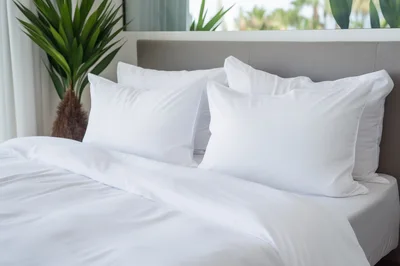 White Bedding With Pillows In A Modern Bedroom