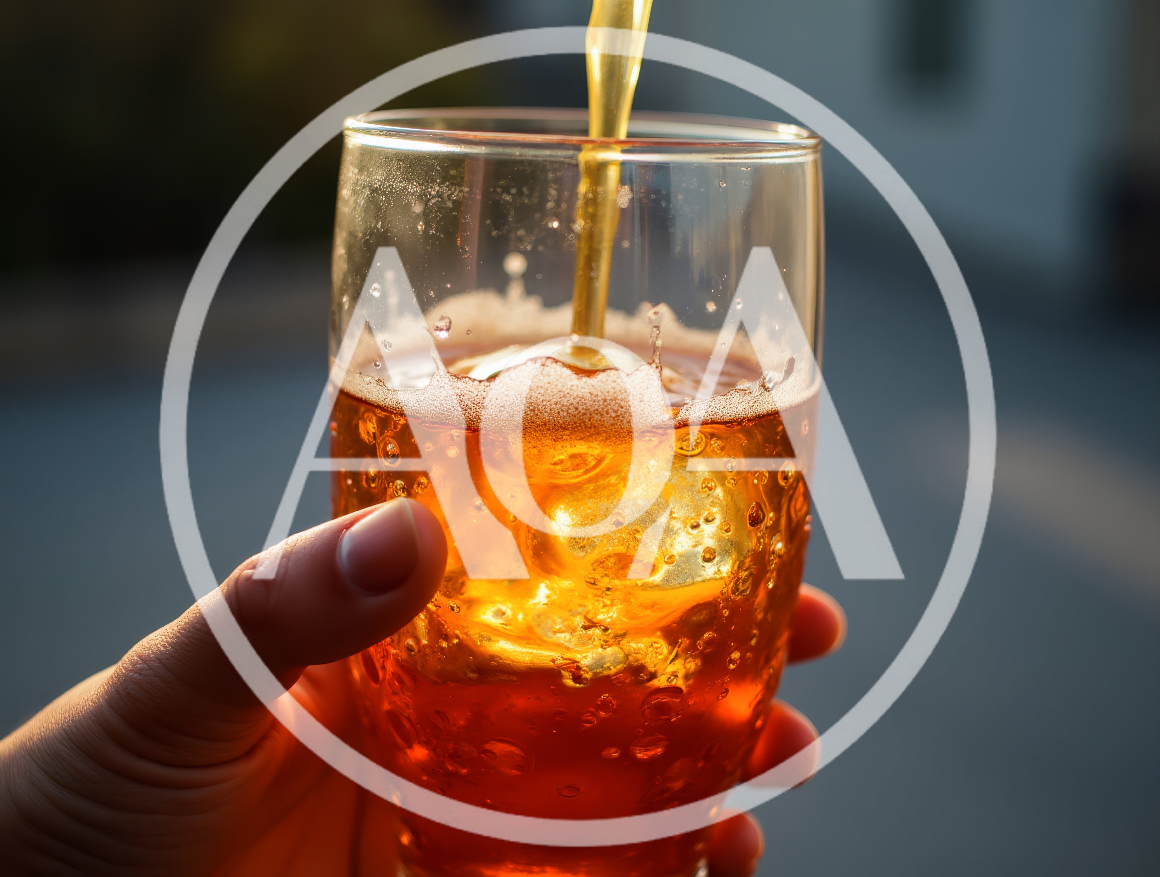 Pouring Golden Beverage Into A Glass With Ice