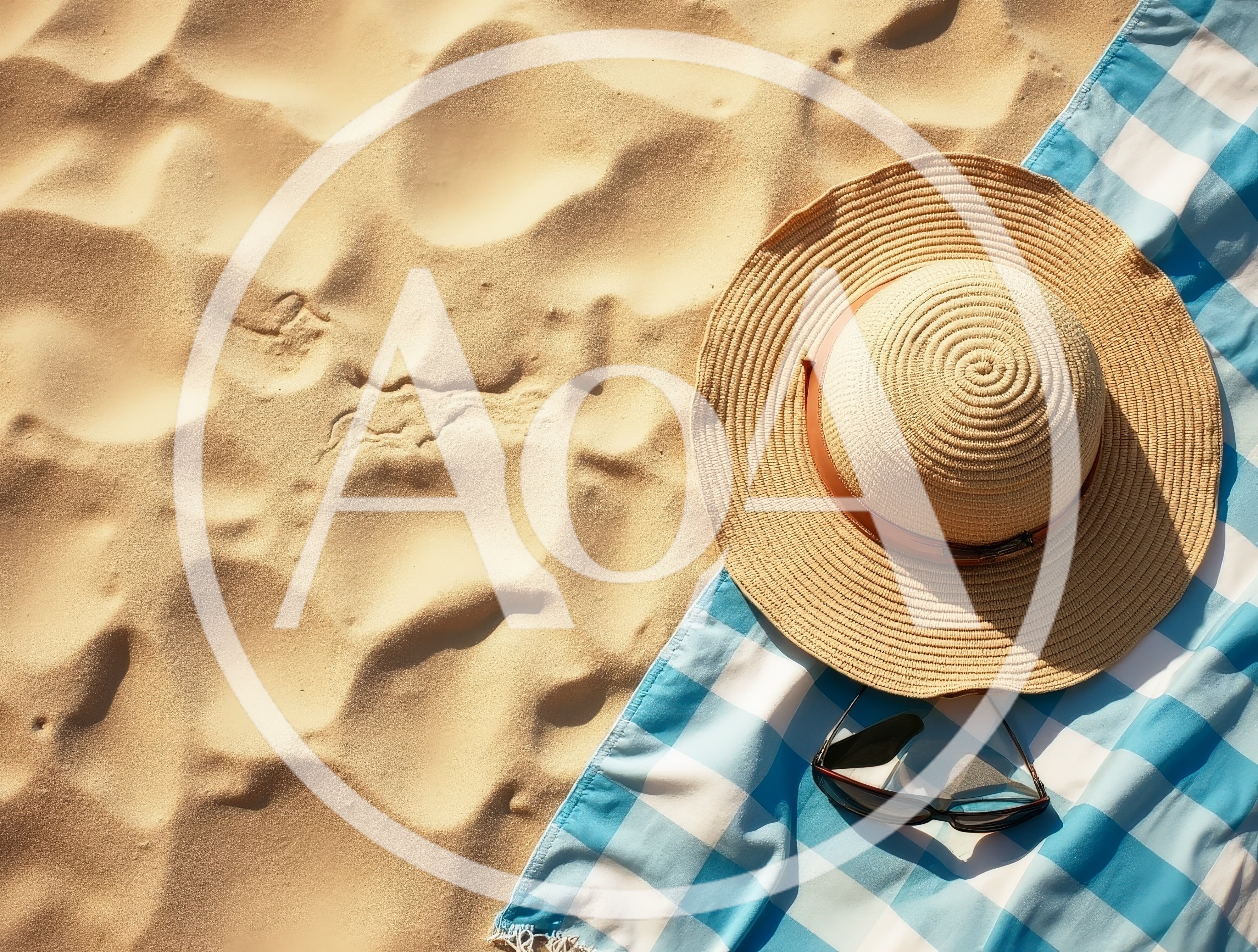 Sun Hat And Sunglasses On A Beach Towel