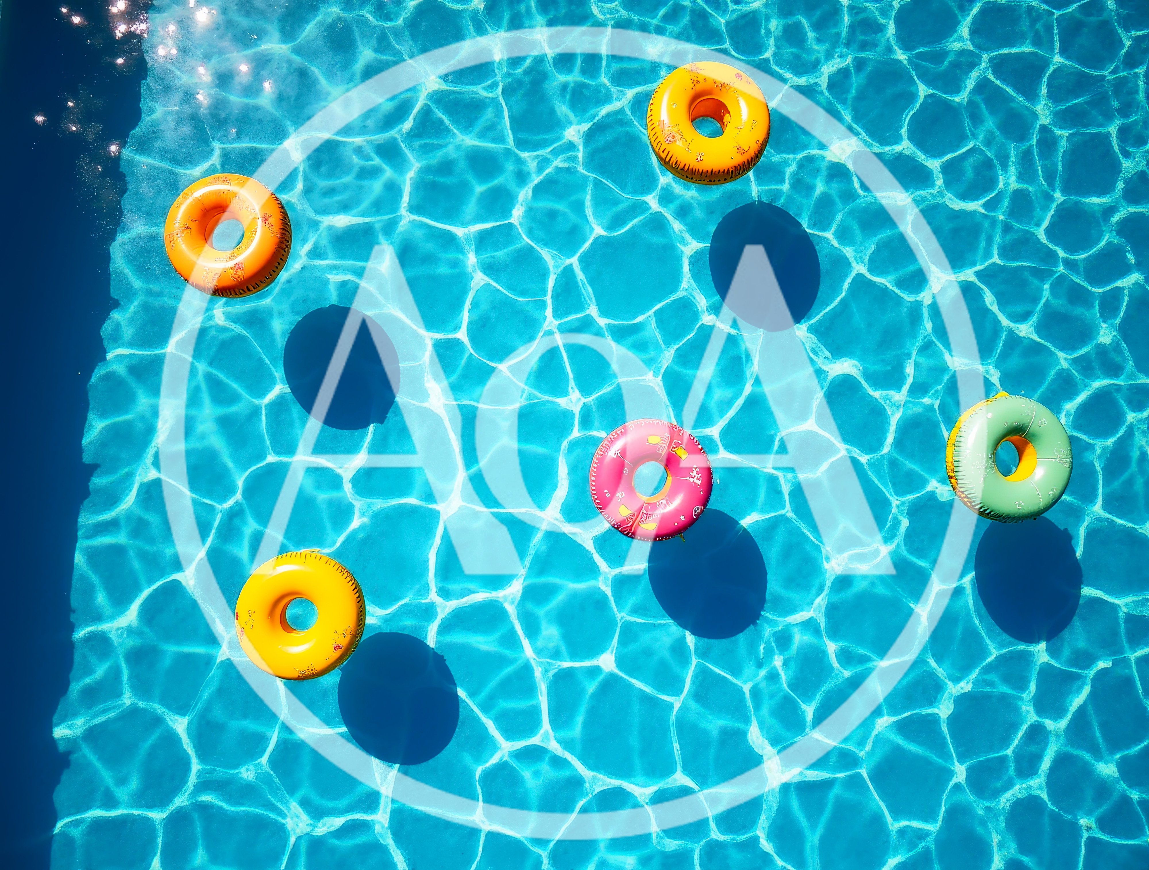 Colorful Inflatable Pool Rings Floating In Swimming Pool