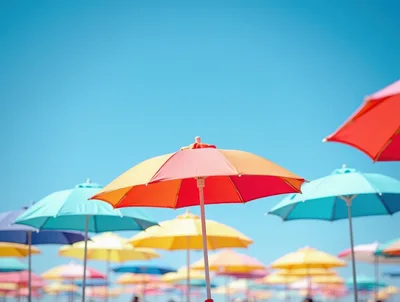 Colorful Beach Umbrellas Under A Clear Blue Sky