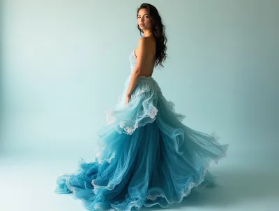 Elegant Woman Posing In Flowing Blue Evening Gown