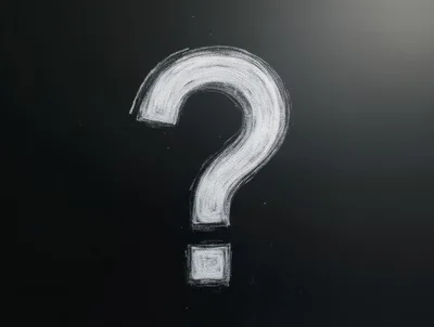 White Chalk Question Mark Drawn On Black Blackboard