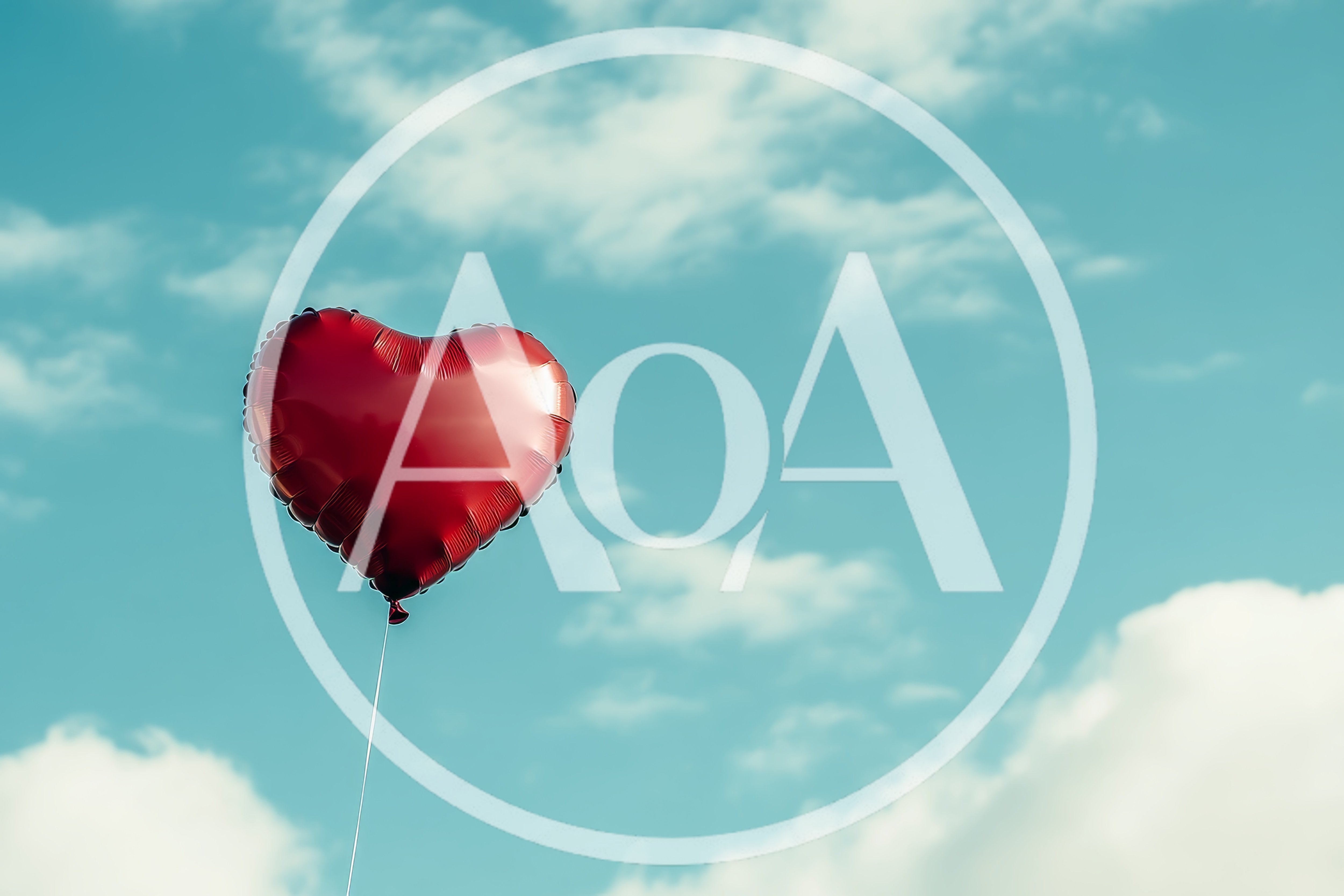 Red Heart Shaped Balloon Floating In Blue Sky