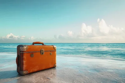 Vintage Leather Suitcase Resting On A Tropical Beach
