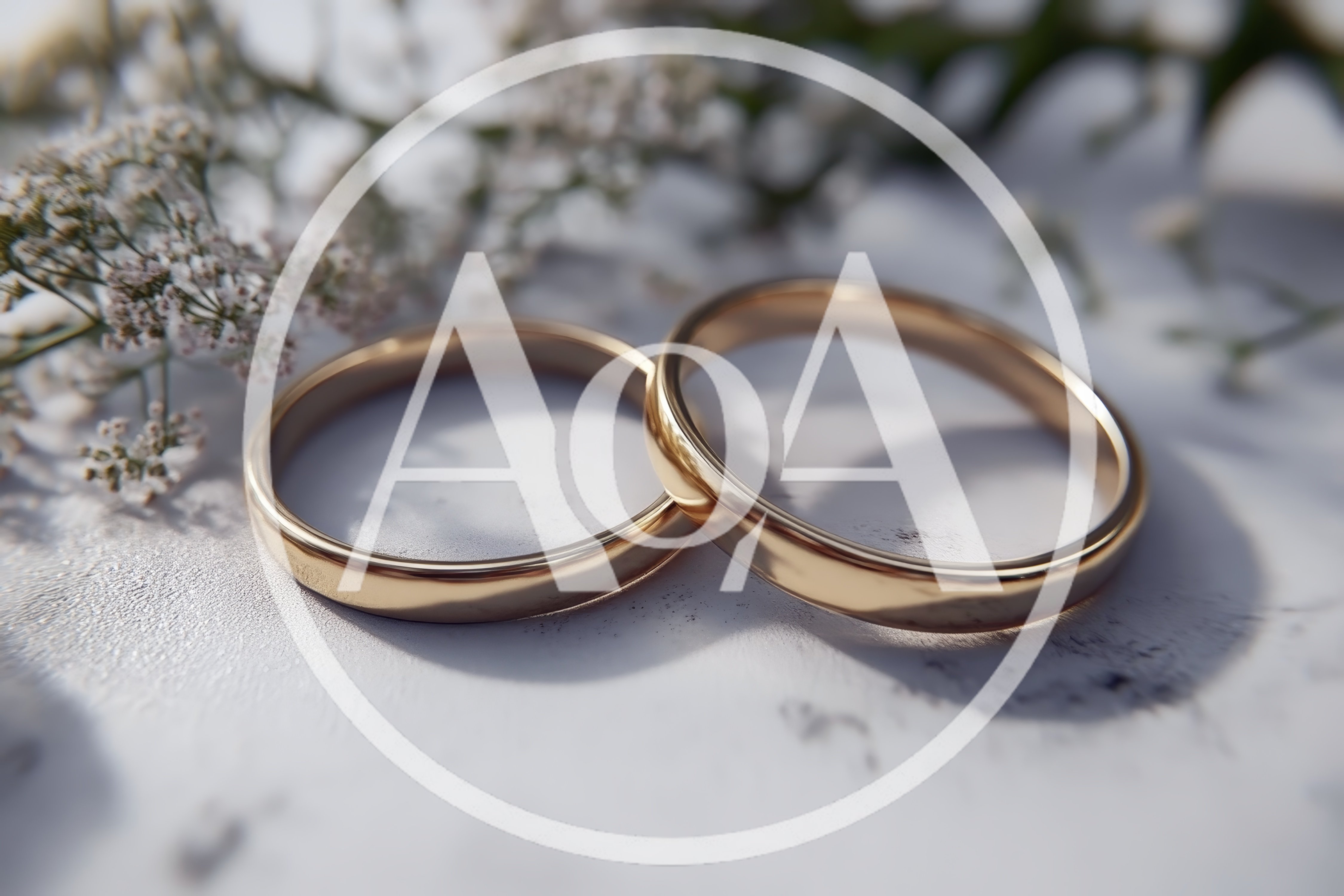 Two Gold Wedding Rings On A Textured Surface