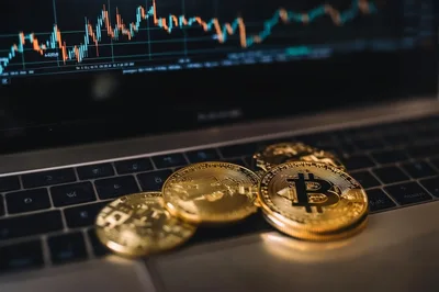 Bitcoin Coins Resting On A Laptop Keyboard