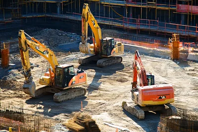 Three Excavators Working at a Large Construction Site