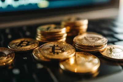 Gold Bitcoin Coins Resting On A Laptop Keyboard
