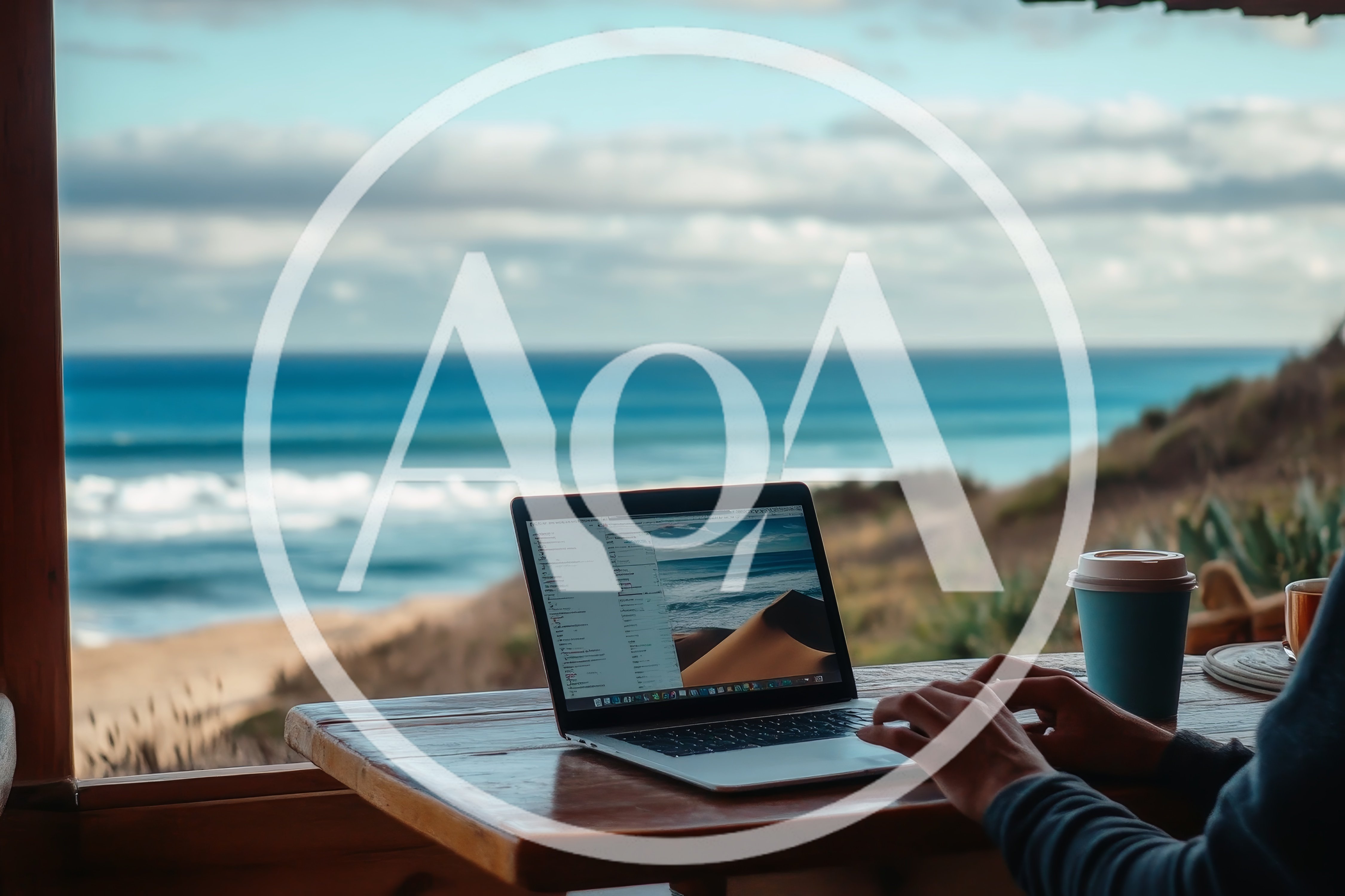Person Working On Laptop Overlooking The Ocean