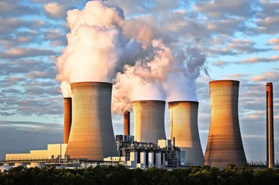 Industrial Cooling Towers Emitting Steam At Power Plant