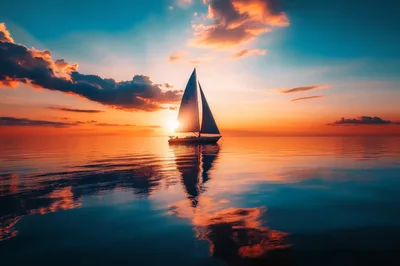 Sailboat Sailing On Calm Ocean During Golden Sunset