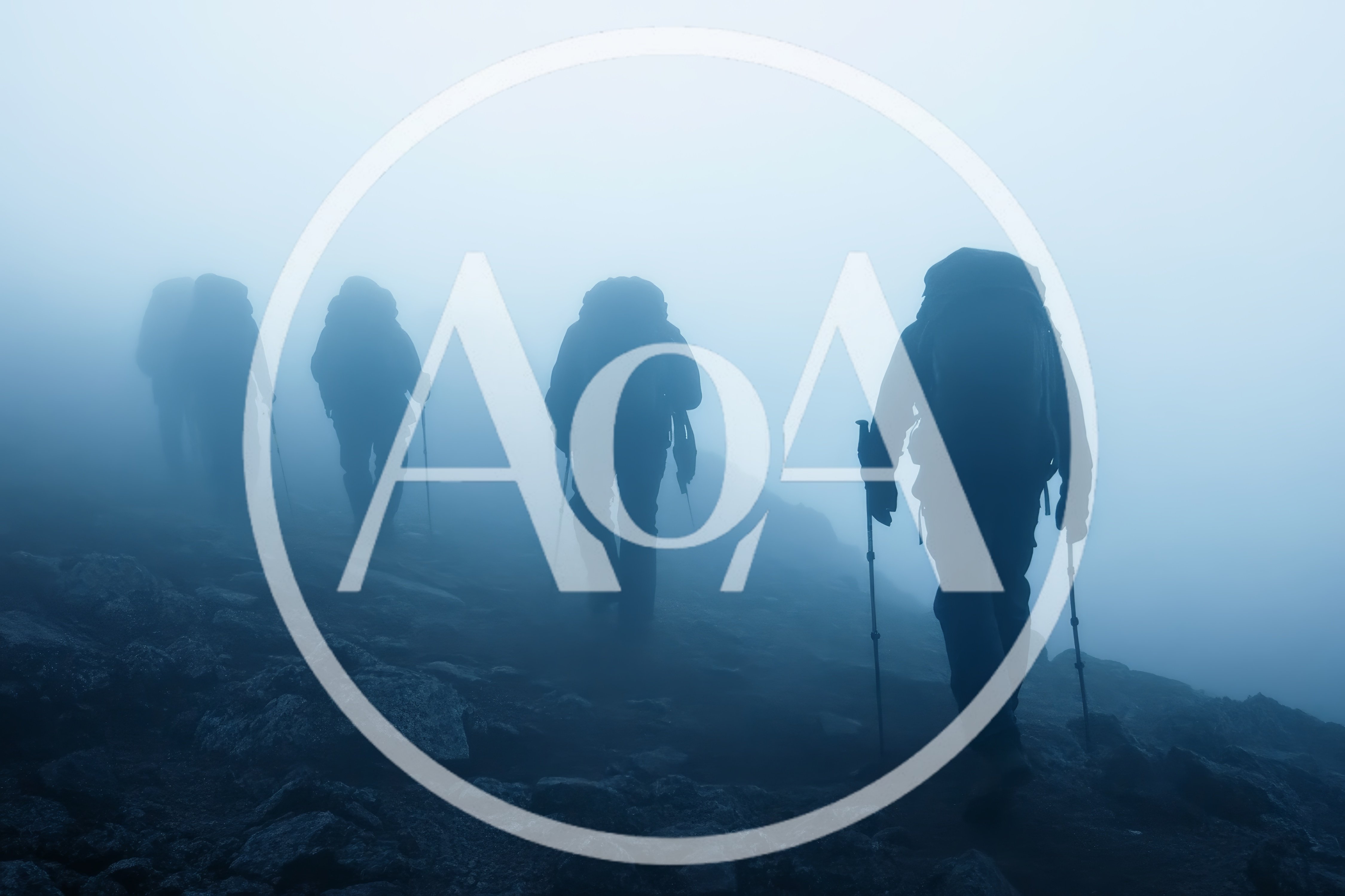 Group Of Hikers Trekking Through Dense Mountain Fog