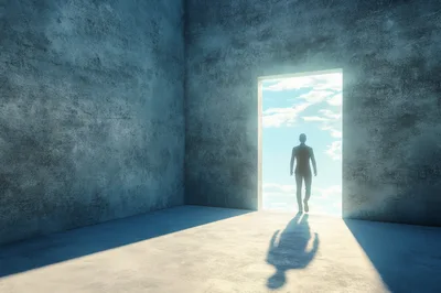 Silhouette Of A Businessman Walking Through A Bright Doorway