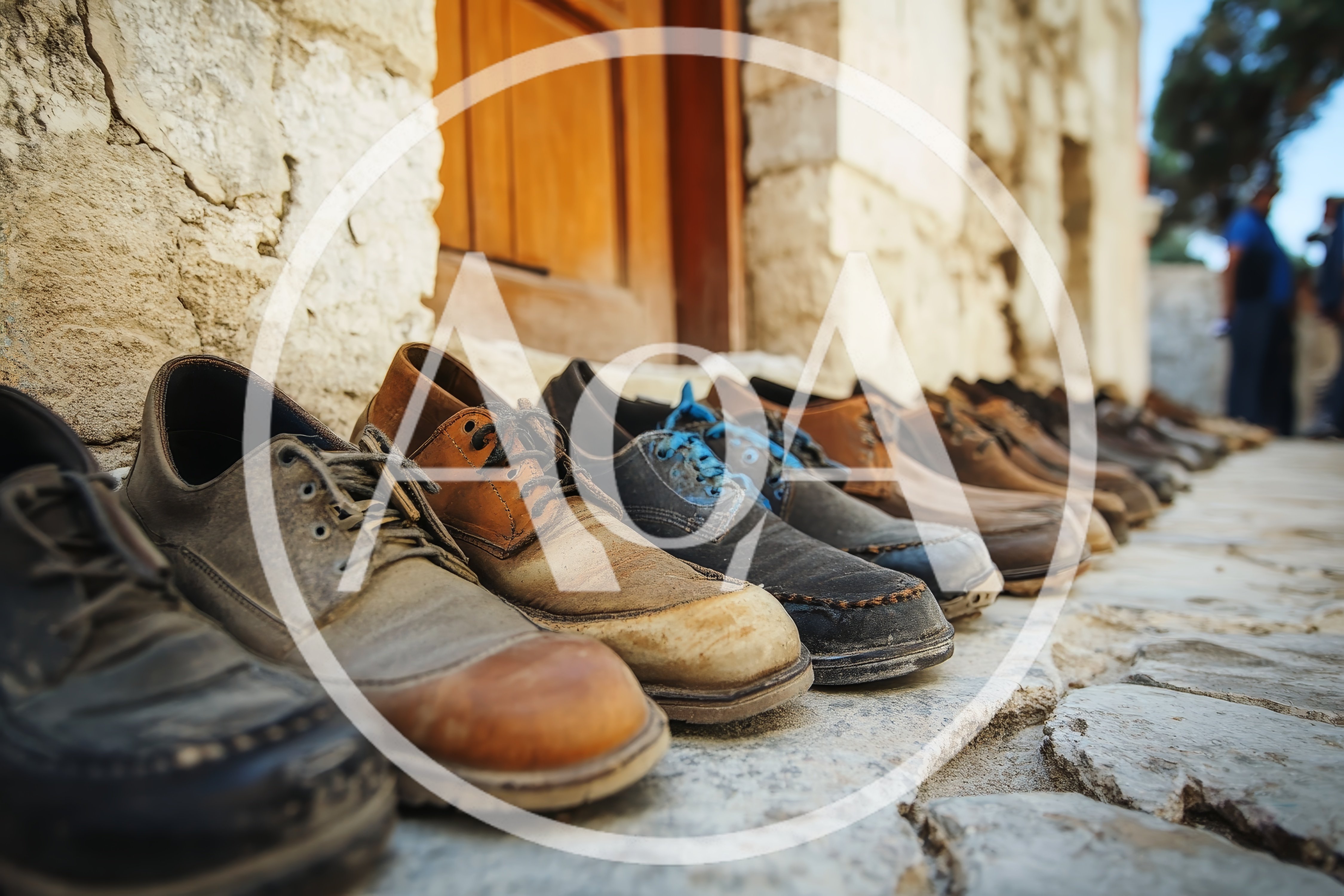 Row Of Worn Leather Shoes On Stone Pavement