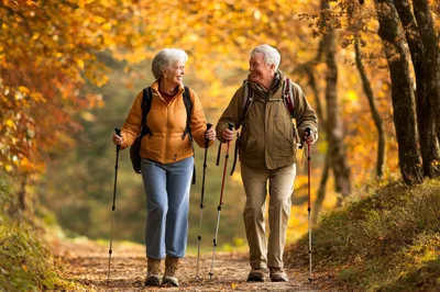 Senior Couple Hiking Together in Autumn Forest