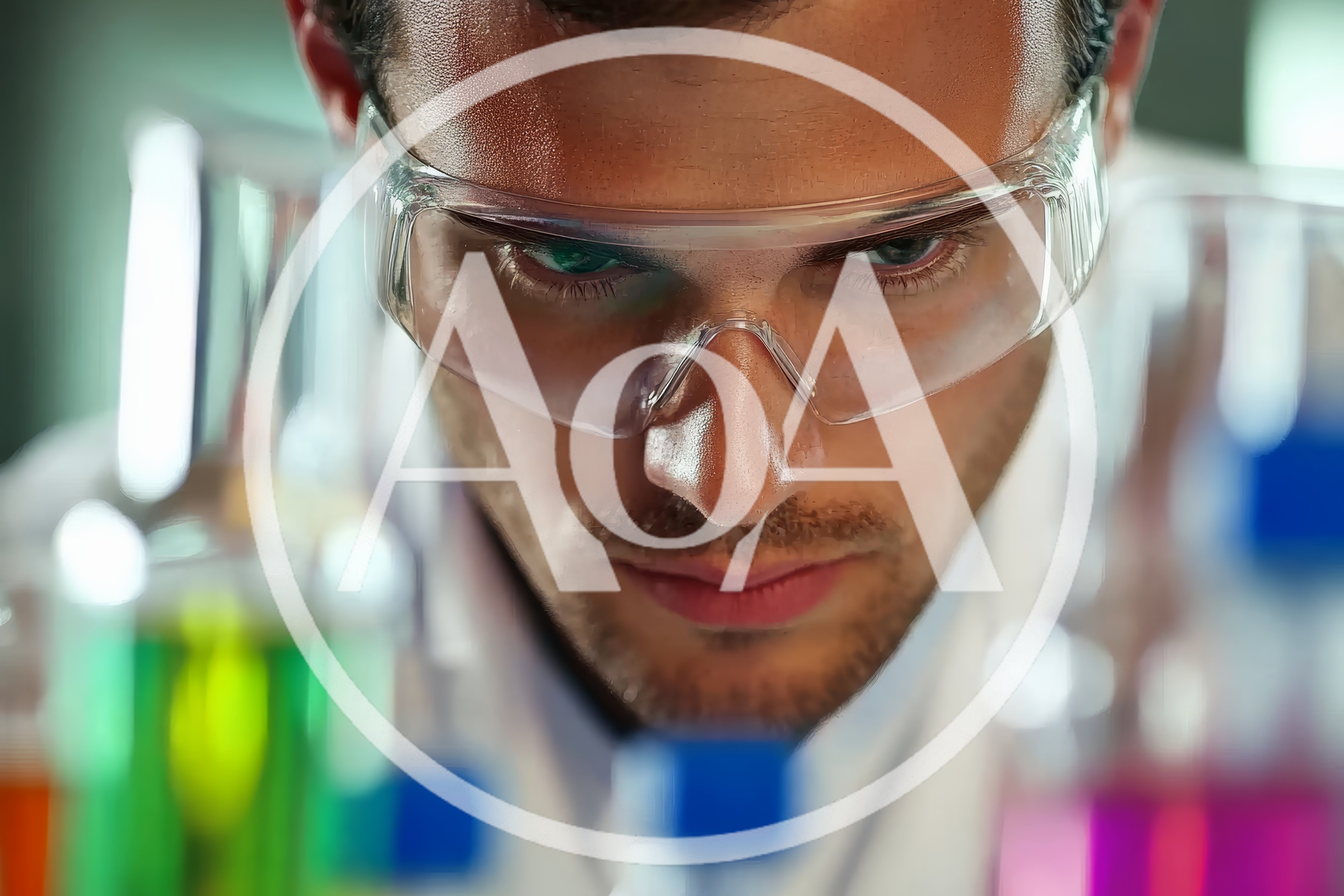 Male Scientist Examining Chemical Solutions In Laboratory