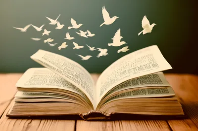Open Book With Paper Birds Flying Out