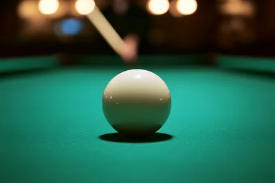 Billiard Cue Striking White Cue Ball On Green Table