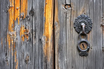 Antique Iron Door Handle On Weathered Wooden Door