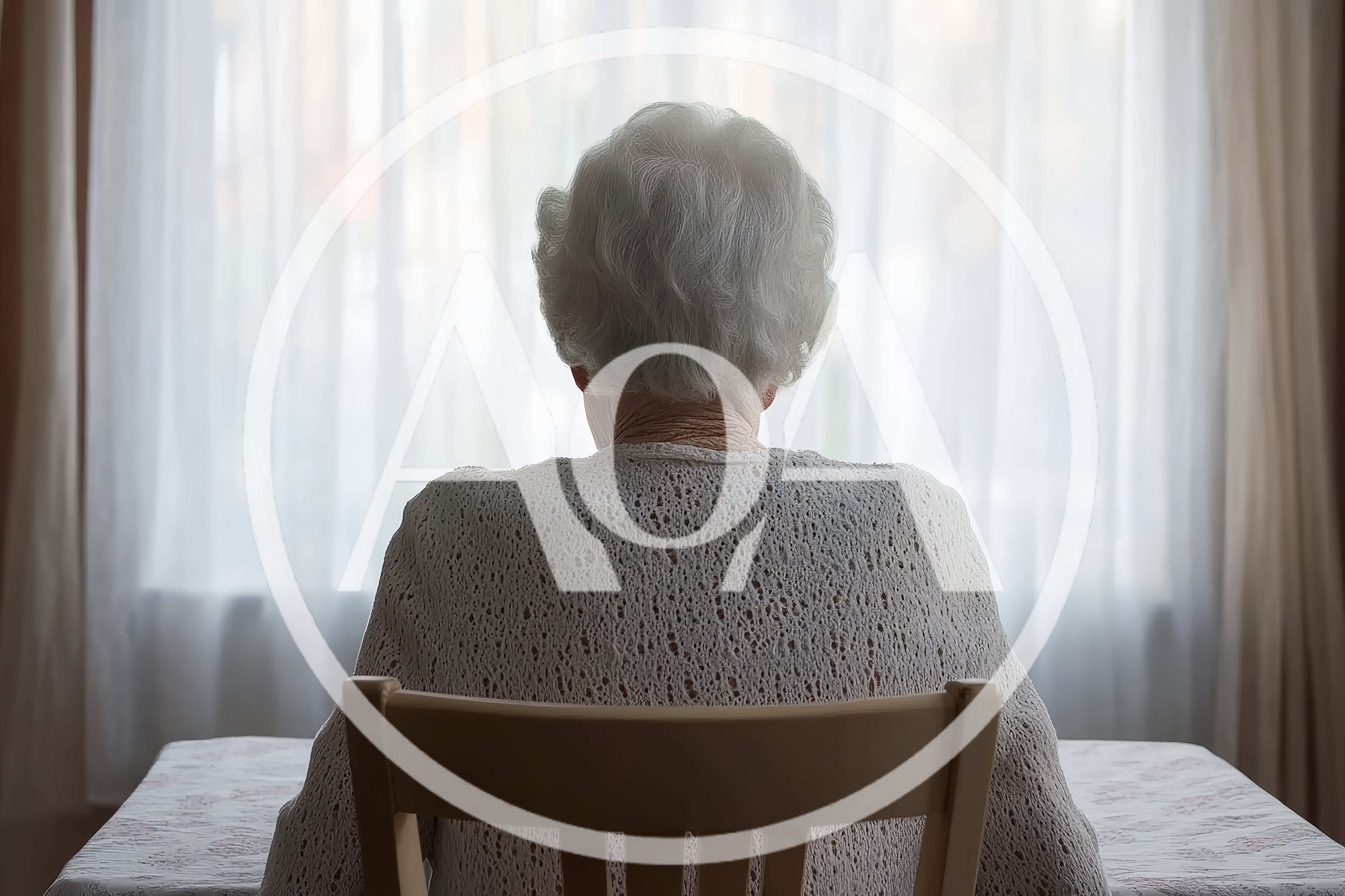 Elderly Woman Sitting Alone Facing A Bright Window