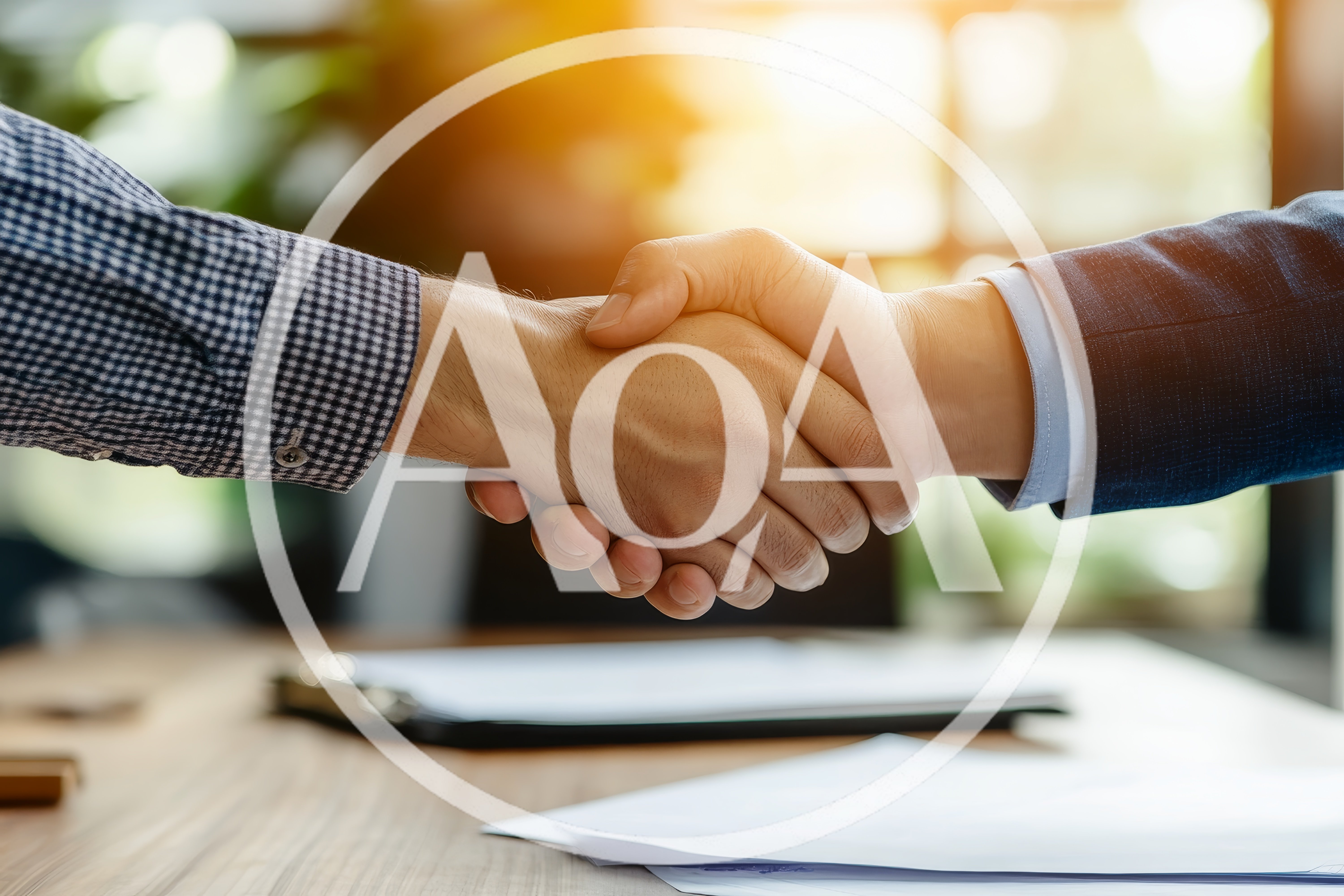 Business Professionals Shaking Hands Over A Desk