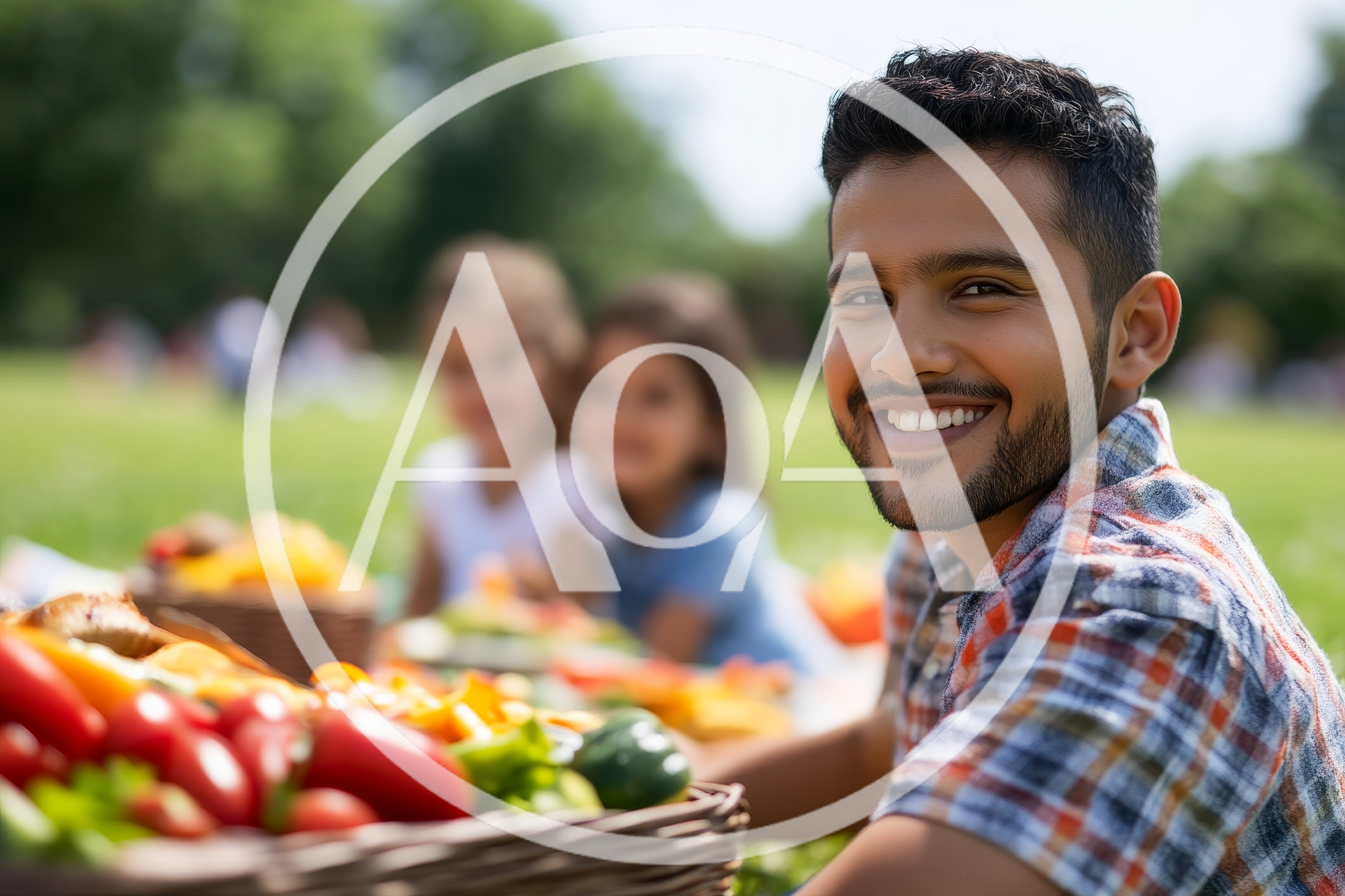 Young Man Smiling During A Family Picnic In The Park