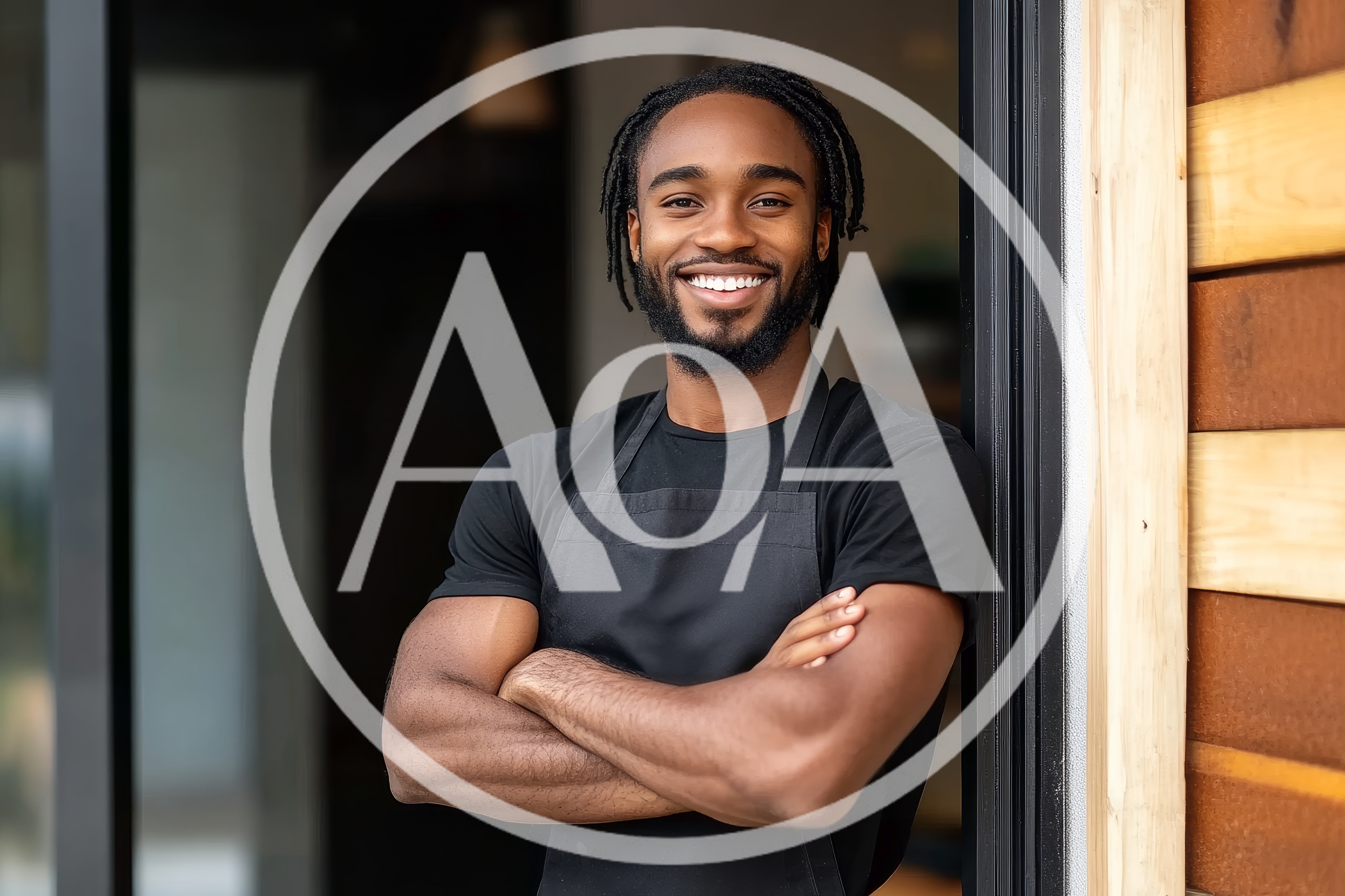 Smiling Black Man Wearing Apron Standing In Doorway