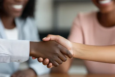 Close Up Of Two Women Shaking Hands