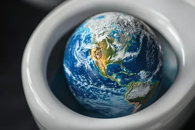 Planet Earth Floating Inside A White Toilet Bowl