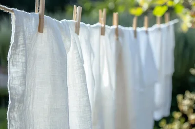 White Linen Fabric Drying On A Clothesline