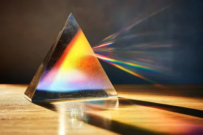 Glass Triangular Prism Refracting Light Into Rainbow Spectrum