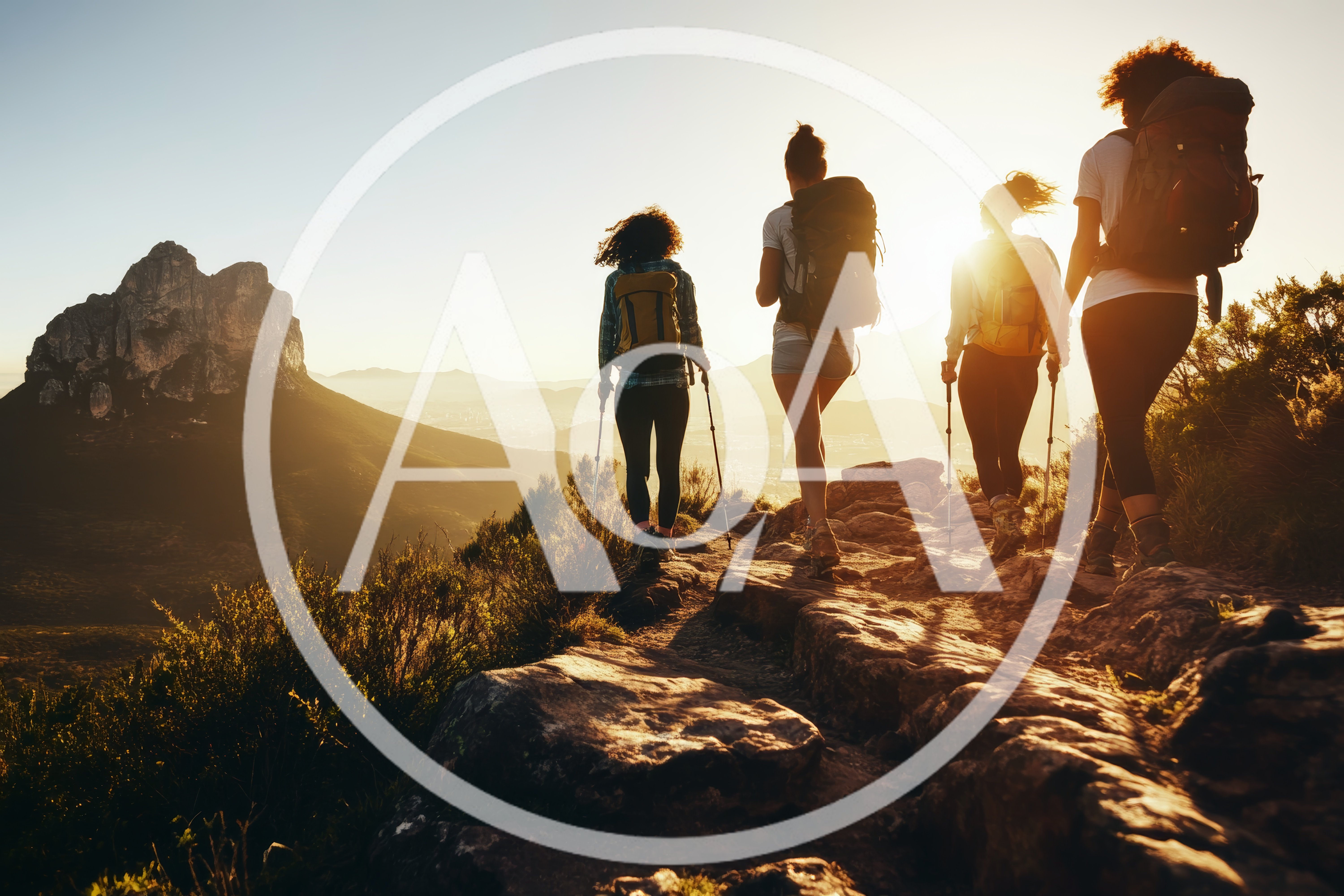 Four Women Hiking On A Mountain Trail At Sunset
