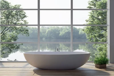Modern Freestanding Bathtub In Minimalist Bathroom With Lake View