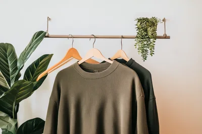 Minimalist Clothing Rack With Olive Green Sweaters