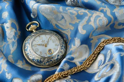 Ornate Antique Pocket Watch on Blue Damask Fabric