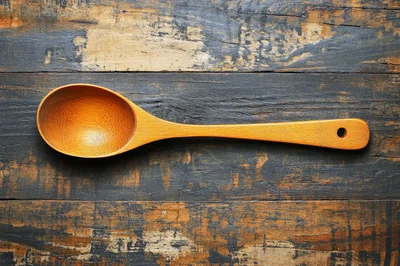 Wooden Spoon Resting On A Distressed Rustic Table